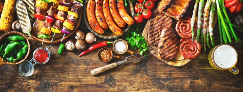 Grilled meat and vegetables on a wooden table