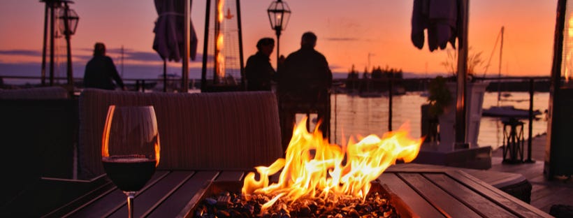 Cosy firepit with couple watching sunset