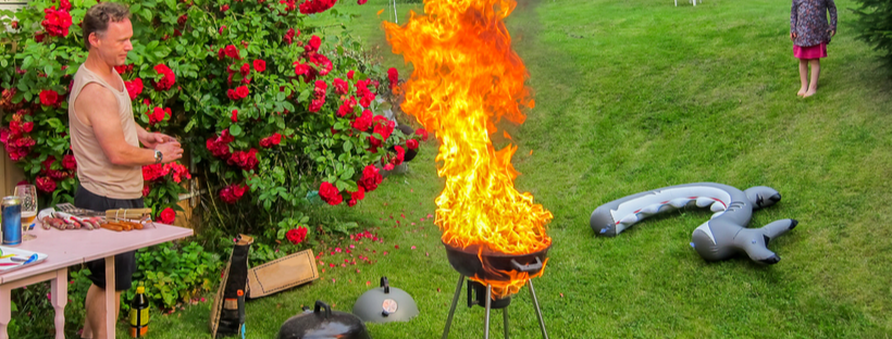 Man watching as grill flames up