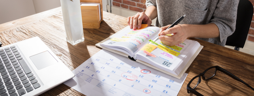 Woman writing on daily planner